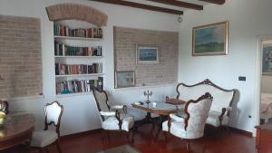 a living room with a table and chairs and bookshelves at Apartments Felicitas in Split