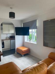 a living room with a couch and a kitchen at Serviced Accommodation in Hull
