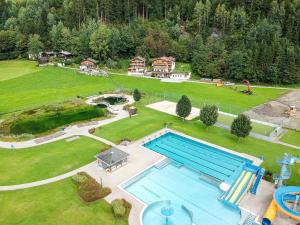 an aerial view of a large swimming pool in a yard at Chalet Dorfbäck in Stumm