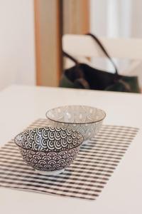 a bowl sitting on a table in front of a mirror at Apartman Sunčica in Lukavica