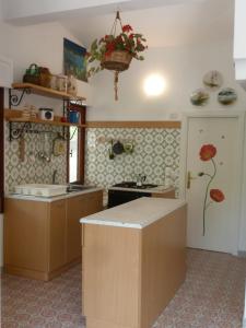 a kitchen with a sink and a counter top at Cottage LeDune profumi mediterranei vicino al mare in Torre Rinalda