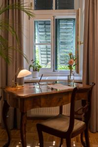 an office with a wooden desk and a window at Louisenvilla in Bad Gleichenberg