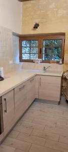 a kitchen with a sink and a counter top at La Grange, Le Domaine de Brugal in Carsac-Aillac +20 photos