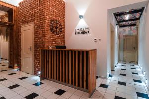a lobby of a restaurant with a brick wall at Apartmány Krmanova in Košice