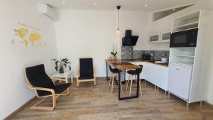 a kitchen with a table and chairs in a room at La Parent'aise in Parentis-en-Born