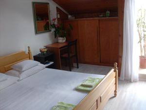 a bedroom with a bed and a table and a chair at Hostel Saint Ursula Rooms in Dubrovnik