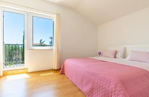 Postel nebo postele na pokoji v ubytování Apartments Villa Maja