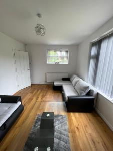 a living room with a couch and a table at Cosy home near NEC, BHX Bullring & Solihull in Birmingham