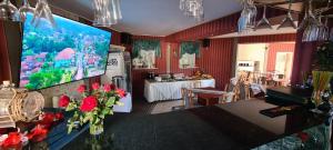 a living room with a large screen on the wall at Apartament Hexagon nr 36 in Grzybowo