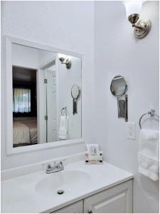a white bathroom with a sink and a mirror at Buckley Inn in Buckley