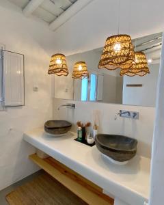 two sinks on a counter in a bathroom with lights at Monte da Aparica in Galeguinha Grande