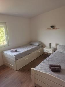 Postel nebo postele na pokoji v ubytování Mini House Mara