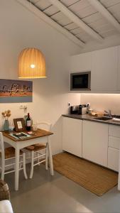 a kitchen with a table and a counter top at Monte da Aparica in Galeguinha Grande