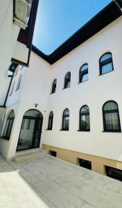 a white building with windows and a courtyard at Miss Saray in Sarajevo