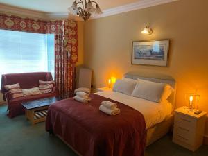 a bedroom with a bed with two towels on it at Atlantic Lodge in Galway