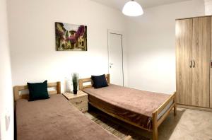 a bedroom with two beds and a cabinet at Villa Tesoro in Kruče