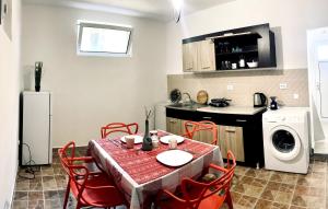 a kitchen and dining room with a table and chairs at Villa Tesoro in Kruče +23 photos