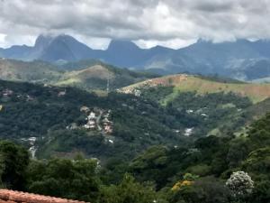 a view of a valley with mountains in the background at Suites em meio a Mata Atlântica in Itaipava