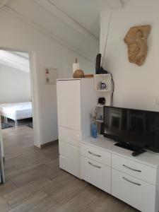 a living room with a flat screen tv on a white cabinet at Apartman Barada in Slatine