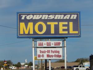 a sign for a tottenham motel with several signs at Townsman Motel in Boise City