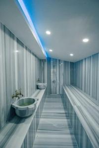 a large bathroom with two sinks and a blue light at FULL MÜSTAKİL GÖL MANZARALI HAVUZLU VİLLA- BTK01 in Sapanca
