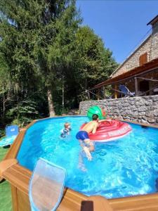 a group of people playing in a swimming pool at Villa Terria in Bagni di Lucca