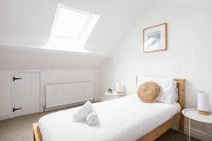 a bedroom with two beds and a window at Cosy period cottage 2min walk to the beach in Portrush