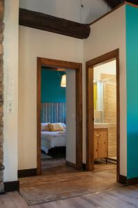 a bedroom with a bed and a mirror at La Borda de Chelis in Broto