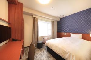 a hotel room with a bed and a tv at Richmond Hotel Tokyo Mejiro in Tokyo