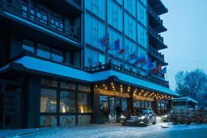 a hotel with a car parked outside of it at International Hotel Sayen in Irkutsk