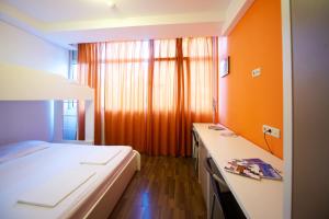 um quarto com uma cama e uma parede laranja em Funk Lounge Hostel em Zagreb