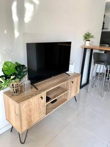 a wooden entertainment center with a flat screen tv at Amazing Apartment in Palermo Hollywood! in Buenos Aires