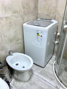 a white toilet and a sink in a bathroom at Amazing Apartment in Palermo Hollywood! in Buenos Aires