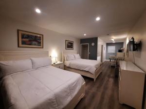 ein Hotelzimmer mit 2 Betten und einem Schreibtisch in der Unterkunft Stardust Hotel in Miami Beach