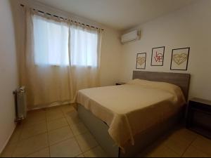 een kleine slaapkamer met een bed en een raam bij Apartamentos Santa Rosa PB3 in Cordoba