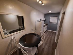 a kitchen with a table and chairs and a refrigerator at Stardust Hotel in Miami Beach +29 photos