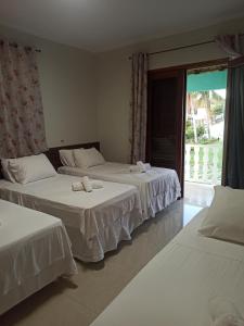 Ένα ή περισσότερα κρεβάτια σε δωμάτιο στο Pousada Villa Mares