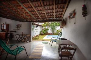 a patio with chairs and a table and a pool at Sertões Hospedaria & Cultura in Carolina