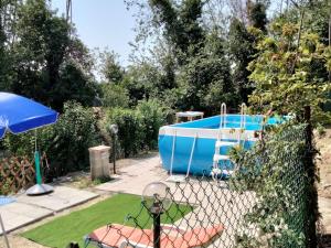 a blue boat in a yard with a fence at Farmhouse in Fano with Pool & Adriatic Views in Montemaggiore al Metauro +19 photos