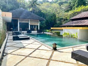a swimming pool in the backyard of a house at Kebun Villas & Resort in Senggigi