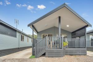 a home with a gray and white house at Ingenia Holidays Lake Macquarie in Mannering Park