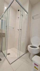 a shower stall in a bathroom with a toilet at Flat América Campos Pelinca in Campos dos Goytacazes