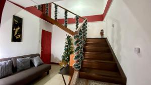 a living room with a staircase with christmas decorations at Apartment 10 minutes by the SJO airport - in Alajuela