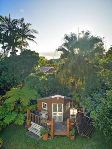 a small house with a deck in the yard at Les Agapanthes in Le Tampon