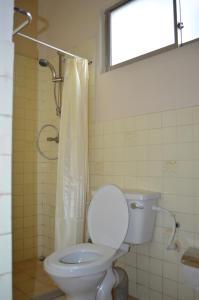 a bathroom with a toilet and a shower with a window at Hanthana Breeze Home Stay in Kandy