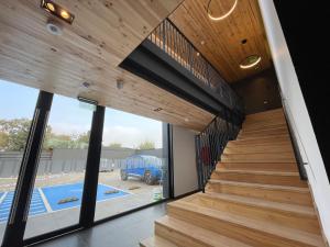 a staircase in a house with a large window at LOFT 31 Villa Alemana BEEHOUSE in Villa Alemana