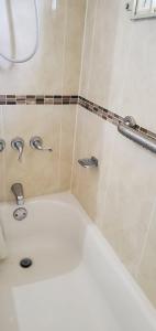 a bathroom with a white toilet and a sink at Hillside Sunrise, 2 Bed 2 Bath in Gated Community, close to beach, food, clubs & shopping Free Parking, Free Wi-Fi in Montego Bay