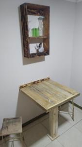 a wooden table with a chair and a mirror at sleep easy 2 in Coquimbo