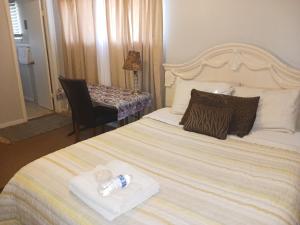 a hotel room with a bed with two water bottles on it at The Happy Home in Jackson