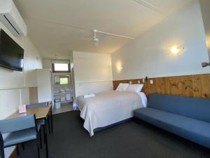 a hotel room with two beds and a television at The Terang Motor Inn in Terang